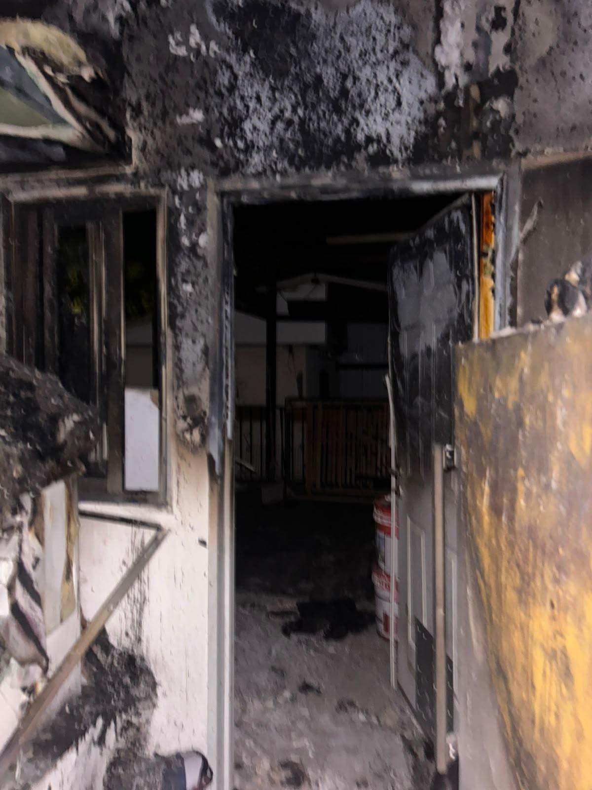The hallway, blackened with soot