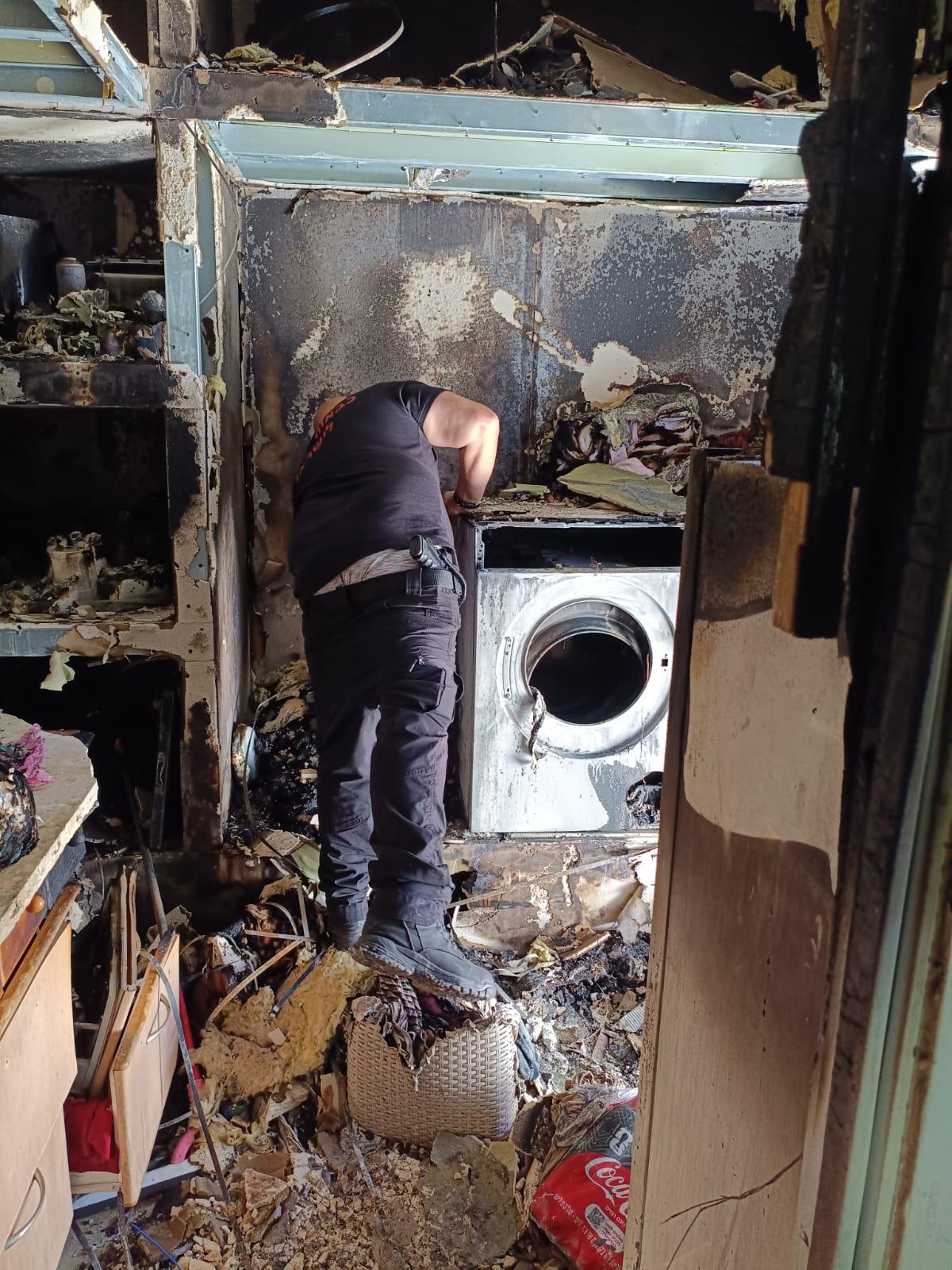 Assessing the damage in the home after the fire was extinguished